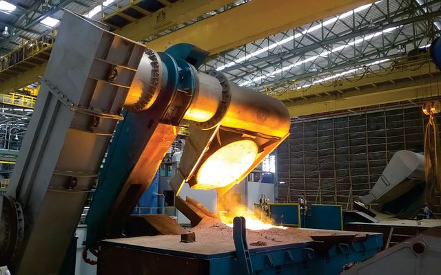 Induction furnace tapping molten metal